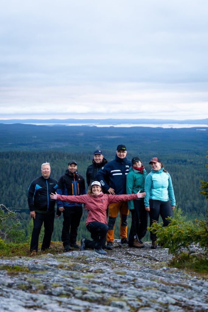 A cheerful group of adult adventure camp participants at Valtavaara in Ruka.